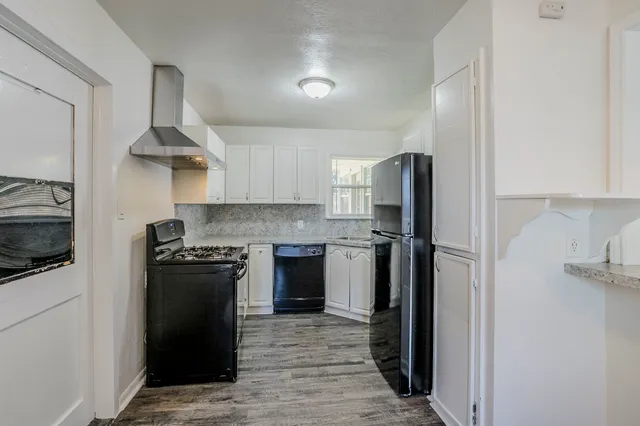 a kitchen with stainless steel appliances granite countertop a refrigerator stove and sink