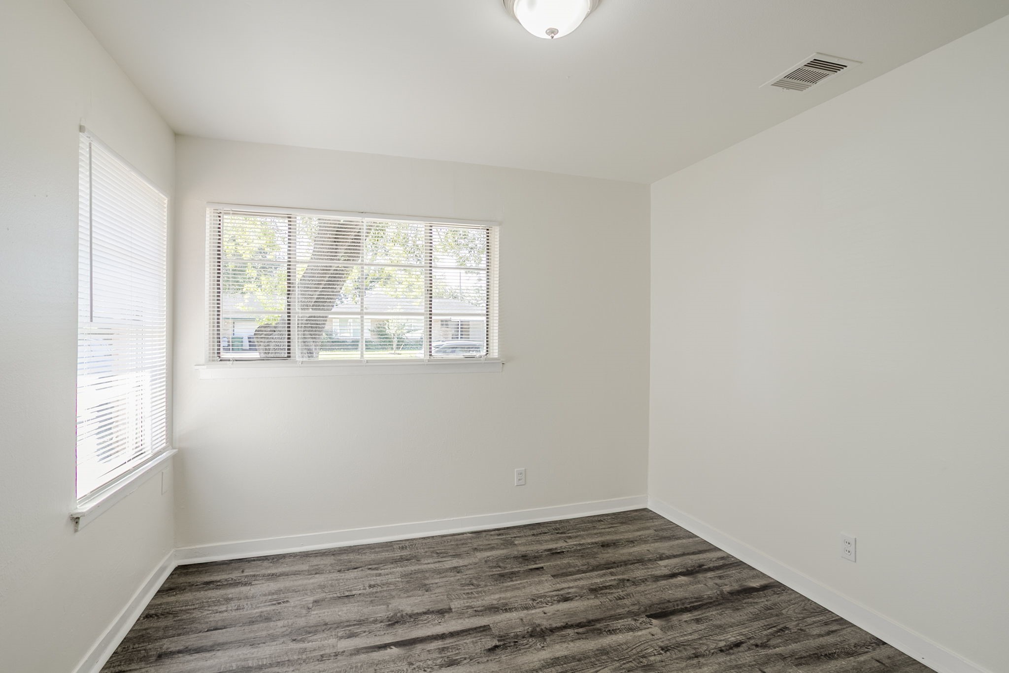6434 Leader Street Houston, TX 77074 - Photo 36 of 46 an empty room with wooden floor and windows