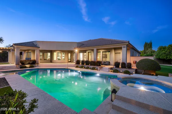 a view of a house with swimming pool and sitting area