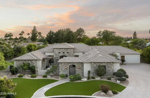 a aerial view of a house with swimming pool and a yard