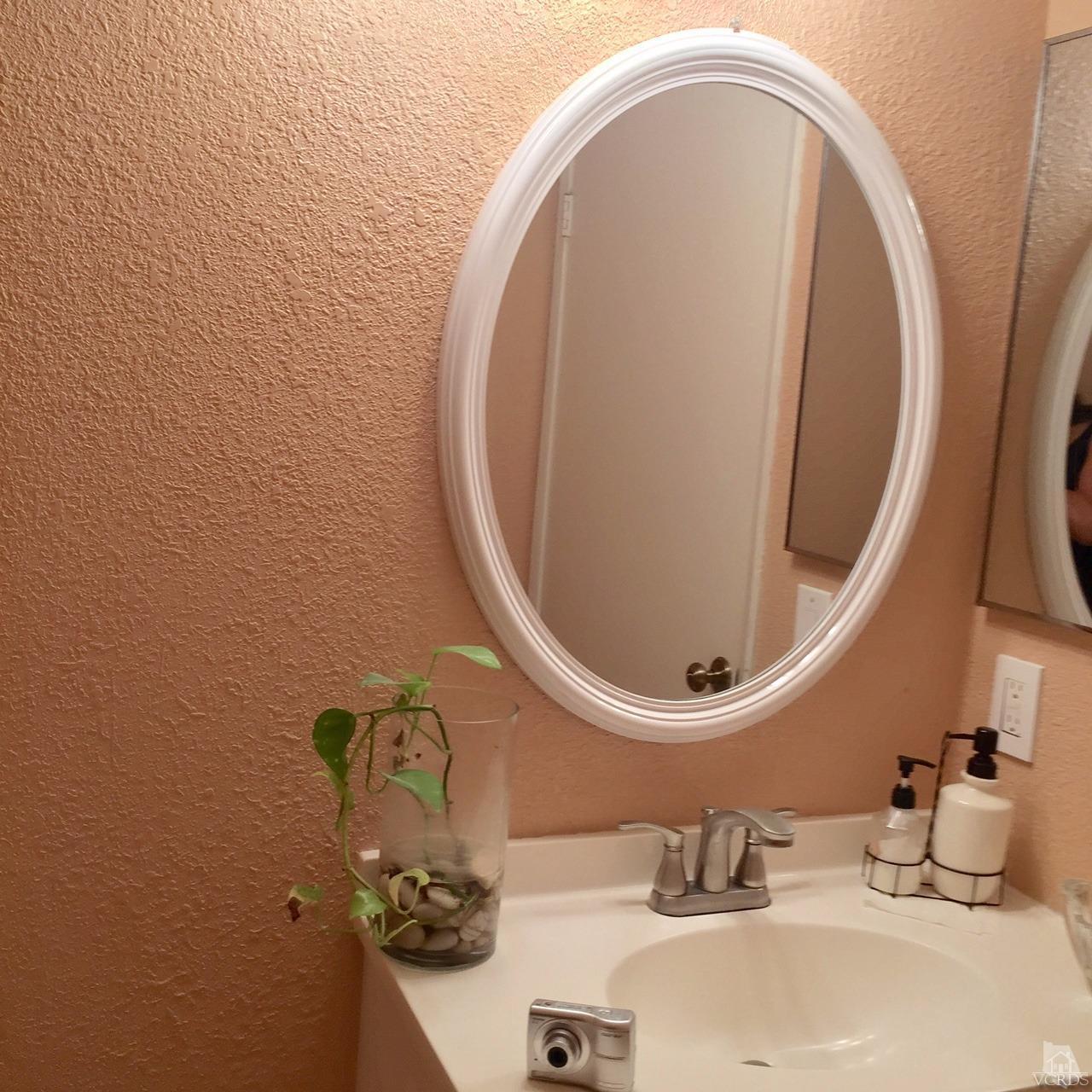 532 Spring Road, Unit 102 Moorpark, CA 93021 - Photo 5 of 10 a bathroom with a sink mirror and vanity