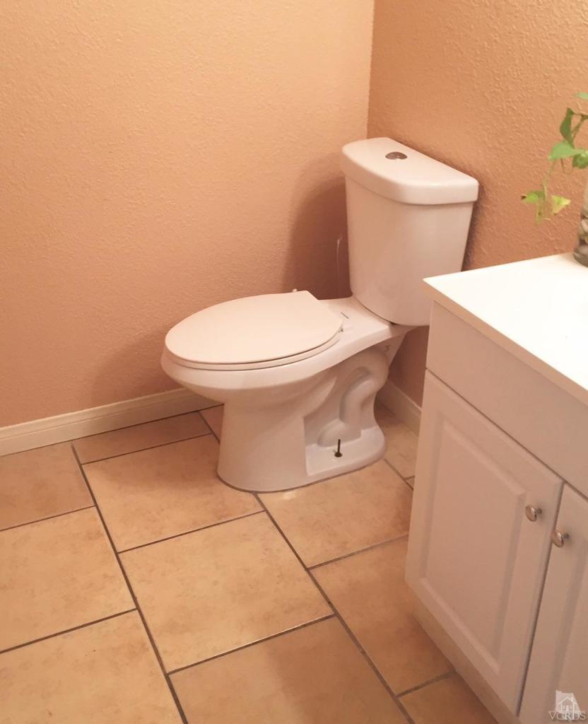 532 Spring Road, Unit 102 Moorpark, CA 93021 - Photo 6 of 10 a white toilet sitting next to a bathroom sink