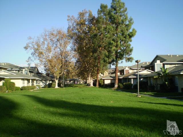 532 Spring Road, Unit 102 Moorpark, CA 93021 - Photo 10 of 10 a view of a house with a big yard and large trees