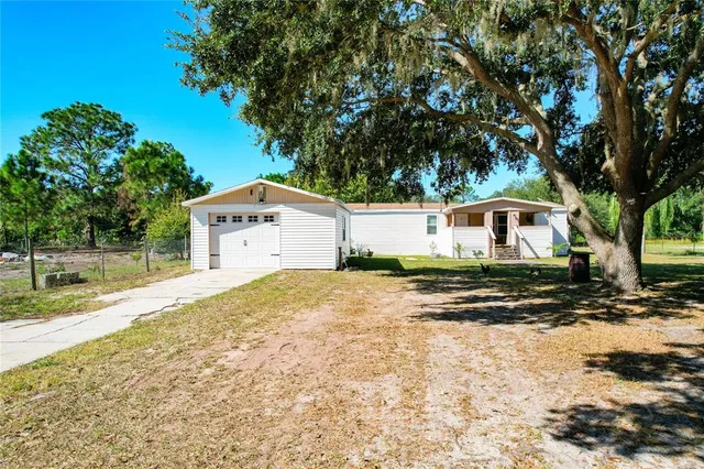 a front view of a house with a yard covered with snow