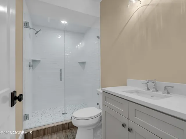 a bathroom with a sink toilet and shower
