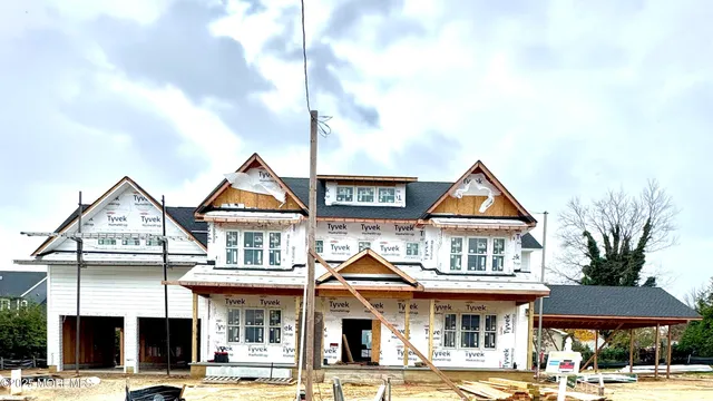 a front view of a residential apartment building with a yard
