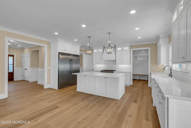 a large kitchen with stainless steel appliances lots of counter space and a sink
