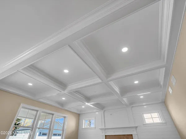 an empty room with windows and chandelier
