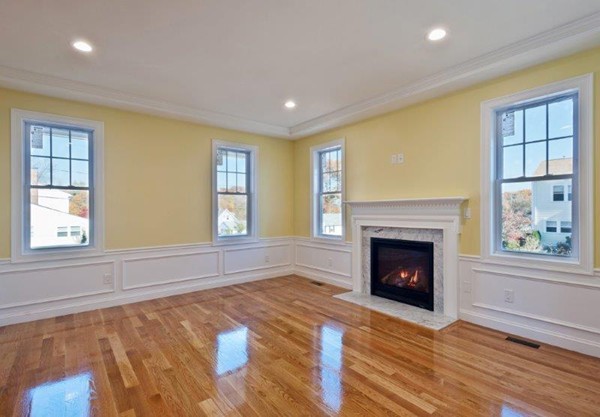 49 Tarbox Street Dedham, MA 02026 - Photo 14 of 30 a living room with a fireplace and windows