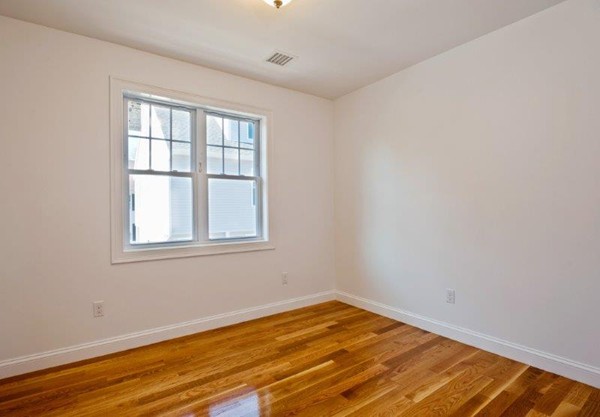 49 Tarbox Street Dedham, MA 02026 - Photo 24 of 30 a view of empty room with wooden floor and fan