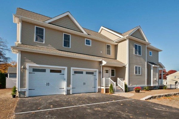 49 Tarbox Street Dedham, MA 02026 - Photo 4 of 30 a front view of a house with a garage