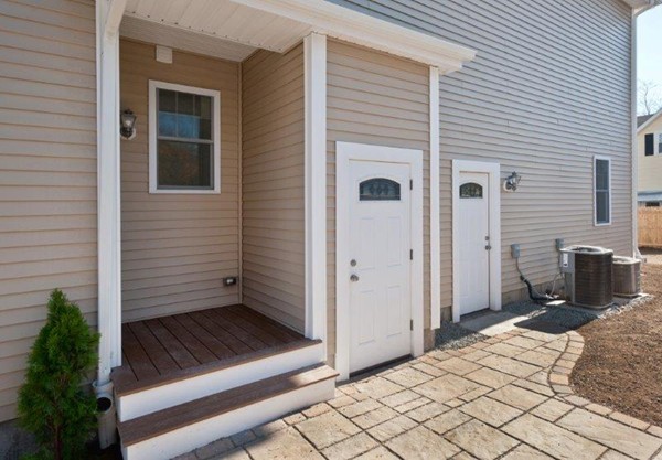 49 Tarbox Street Dedham, MA 02026 - Photo 6 of 30 a view of a porch with wooden floor and a refrigerator