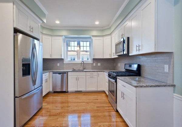 49 Tarbox Street Dedham, MA 02026 - Photo 9 of 30 a kitchen with stainless steel appliances granite countertop a refrigerator sink and cabinets
