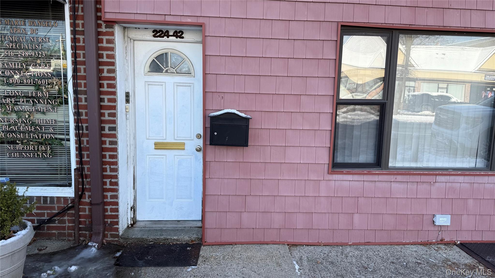 a front view of a house with a brick wall