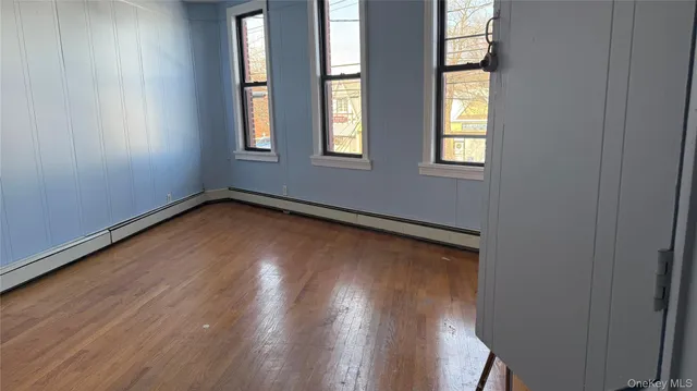a view of a room with wooden floor and windows