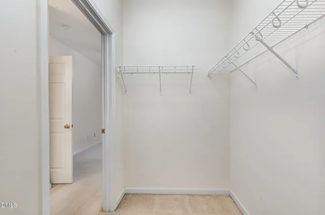 a large bed sitting in a bedroom next to a window