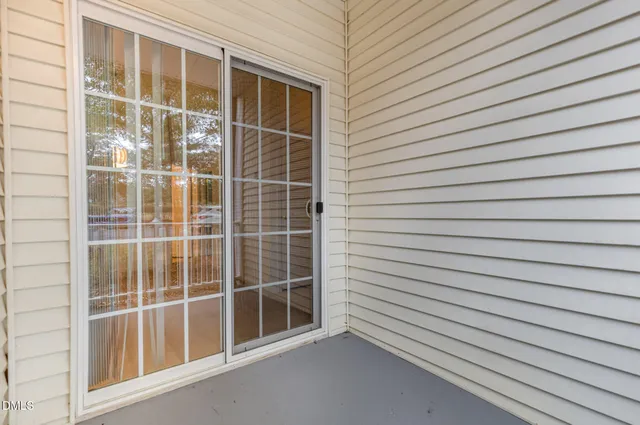 a view of a street with wooden fence