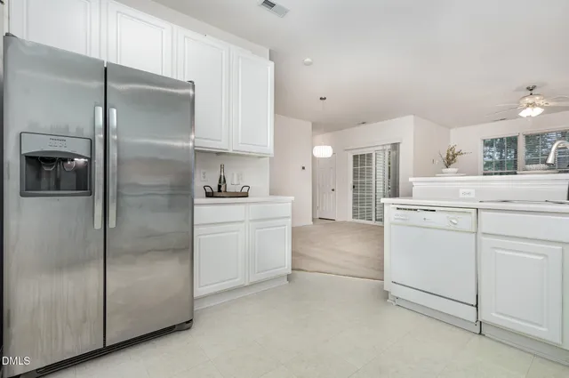 a kitchen with a sink cabinets and appliances