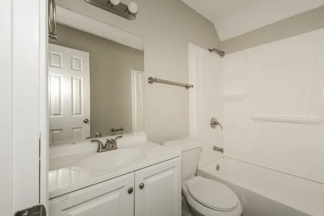 a bathroom with a sink toilet vanity and shower
