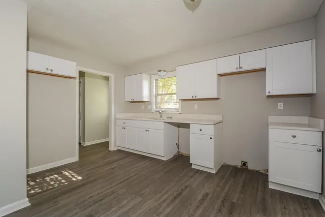 a kitchen with sink cabinets and wooden floor
