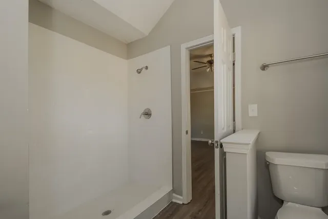 a bathroom with a toilet and a shower