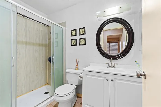 a bathroom with a sink a mirror and toilet