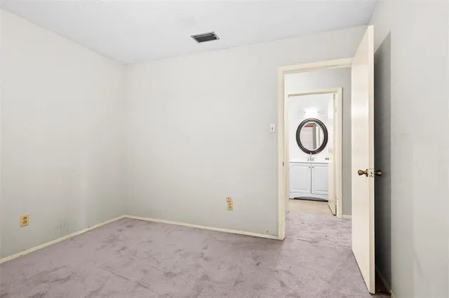 an empty room with a door and a window