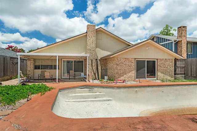 a front view of a house with a yard table and chairs