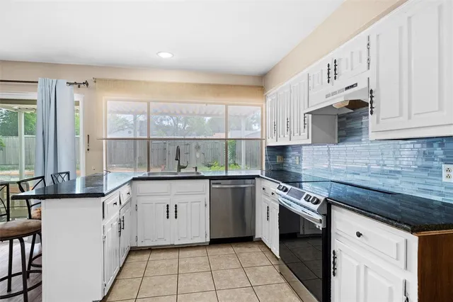 a kitchen with a sink stove and cabinets