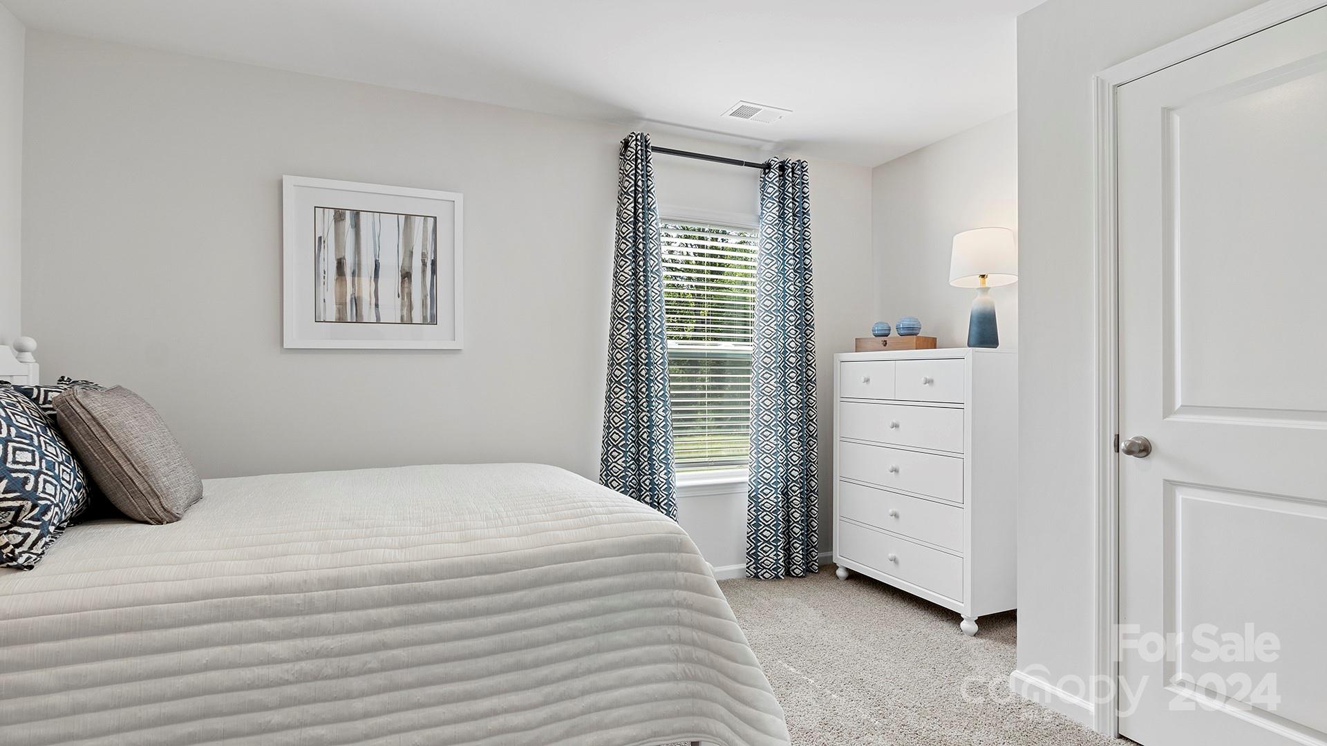 509 Jaca Lane Arden, NC 28704 - Photo 14 of 28 a bedroom with a bed and a window