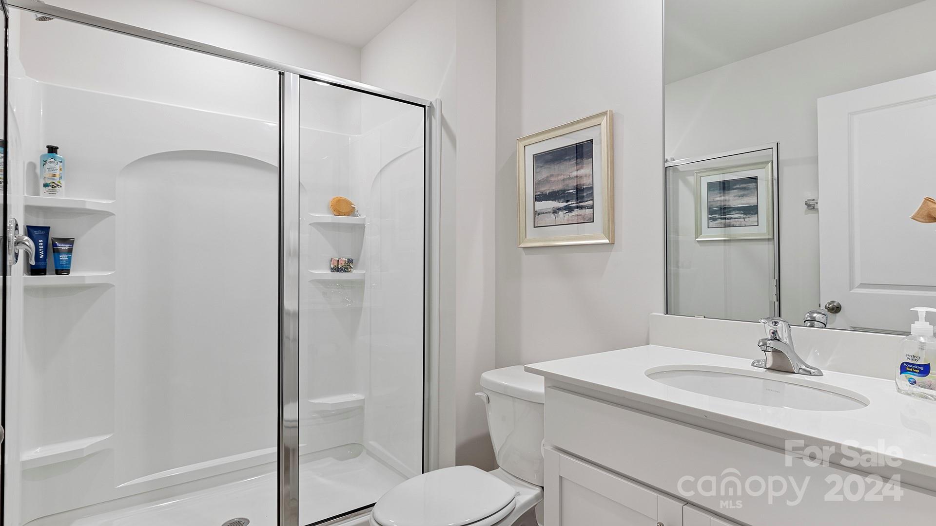 509 Jaca Lane Arden, NC 28704 - Photo 16 of 28 a bathroom with a granite countertop sink toilet and shower