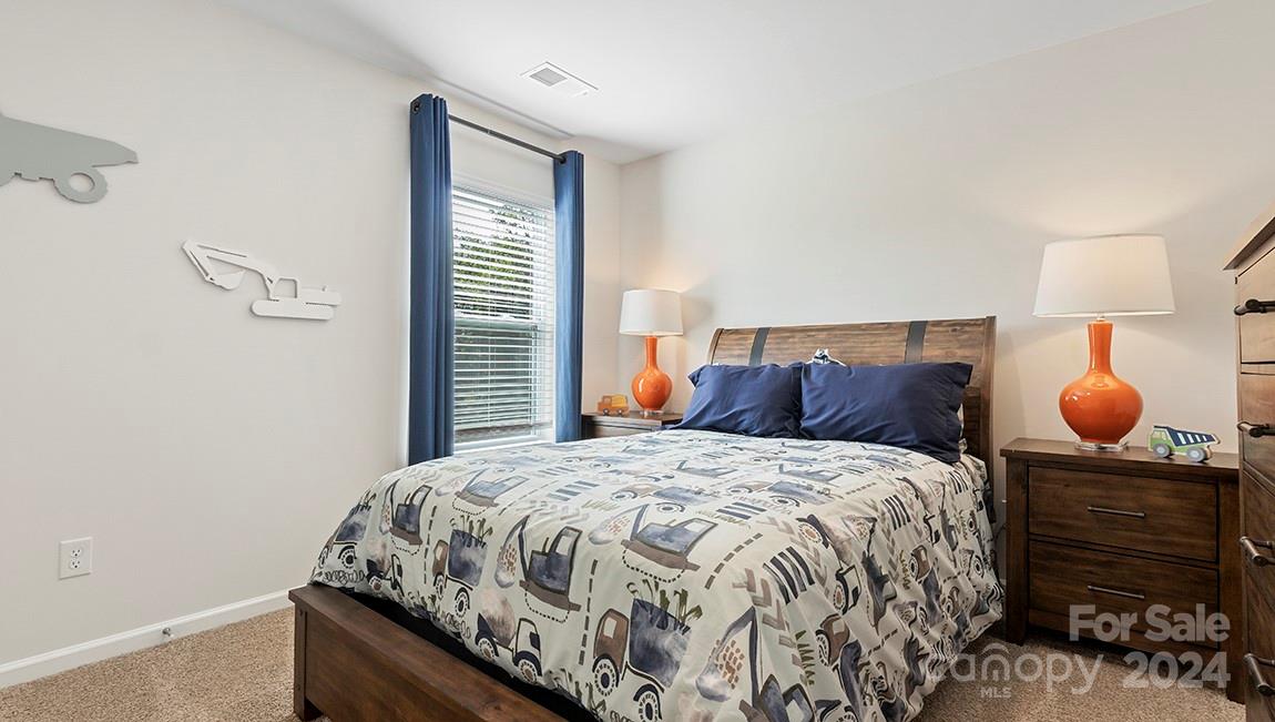 509 Jaca Lane Arden, NC 28704 - Photo 21 of 28 a bedroom with a bed and window