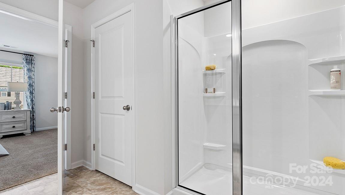 509 Jaca Lane Arden, NC 28704 - Photo 27 of 28 a view of a bathroom with a shower and a sink