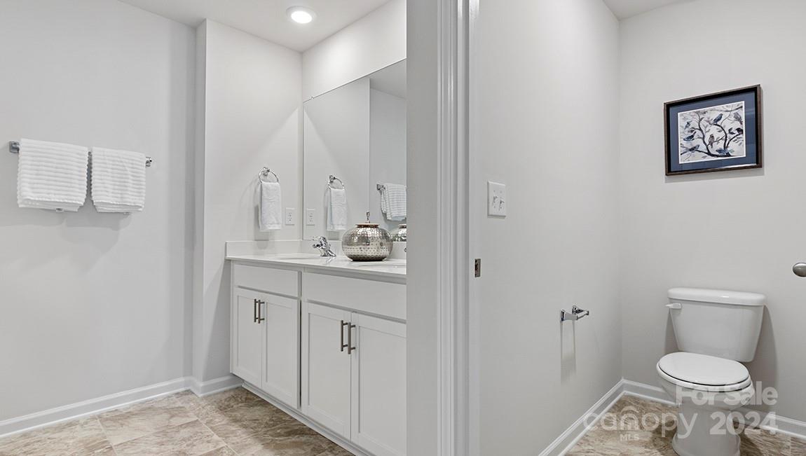 509 Jaca Lane Arden, NC 28704 - Photo 28 of 28 a bathroom with a toilet sink and mirror