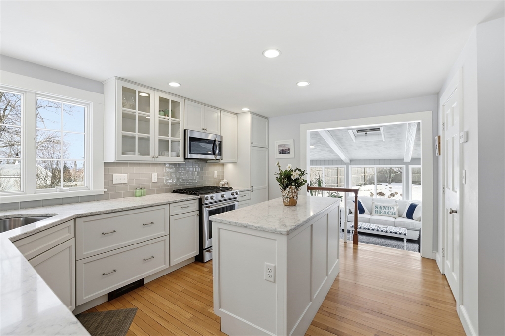 63 Bancroft Road Cohasset, MA 02025 - Photo 7 of 41 a large white open kitchen with stainless steel appliances granite countertop a stove and a sink