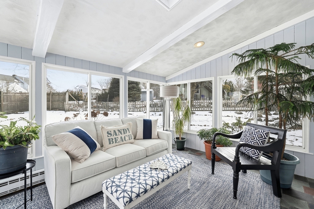 63 Bancroft Road Cohasset, MA 02025 - Photo 9 of 41 a living room with furniture and a floor to ceiling window