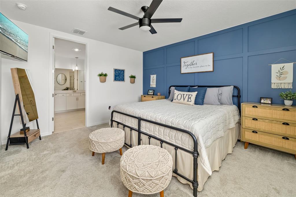 14086 Ginnie Spgs Way Parrish, FL 34219 - Photo 12 of 49 a bedroom with a bed and furniture