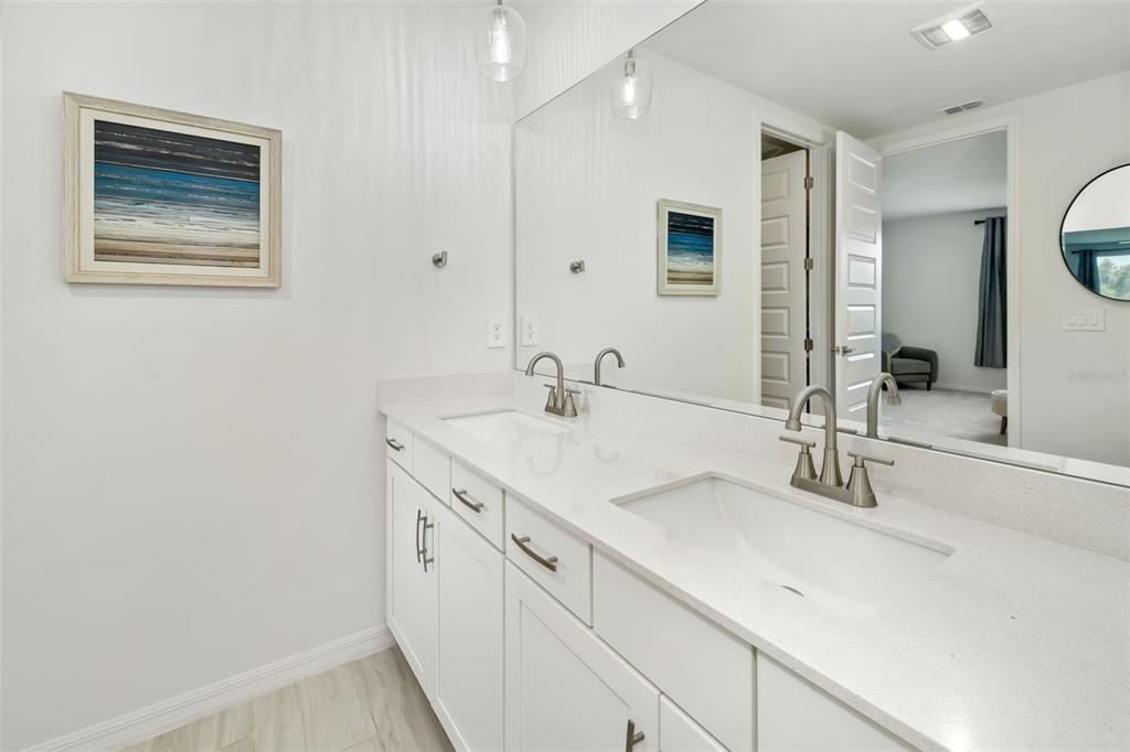 14086 Ginnie Spgs Way Parrish, FL 34219 - Photo 15 of 49 a bathroom with a double vanity sink and a mirror