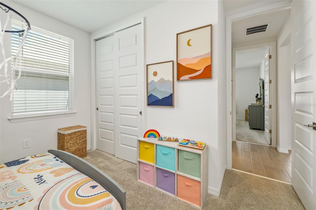 14086 Ginnie Spgs Way Parrish, FL 34219 - Photo 17 of 49 a bedroom with a bed and a painting on the wall
