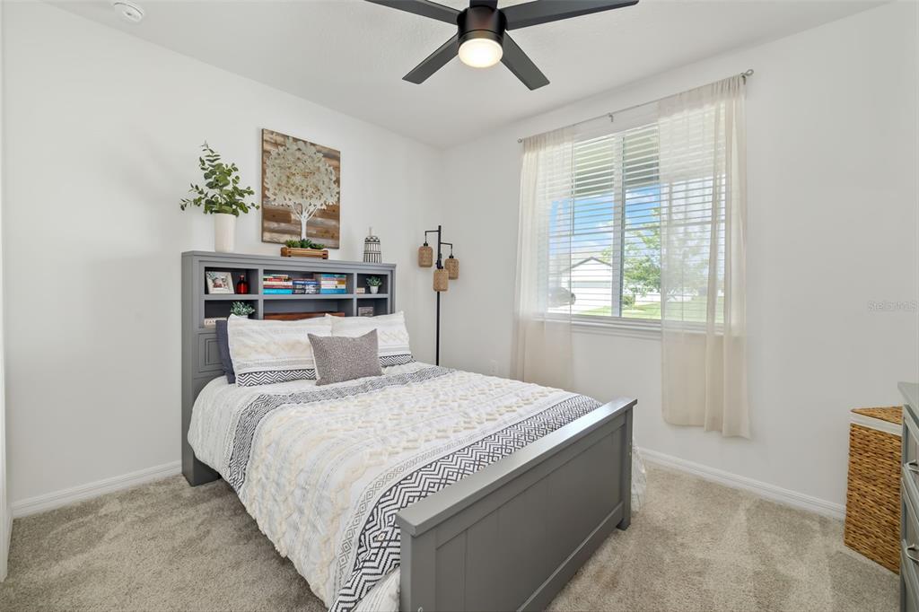 14086 Ginnie Spgs Way Parrish, FL 34219 - Photo 19 of 49 a bedroom with a bed and a window