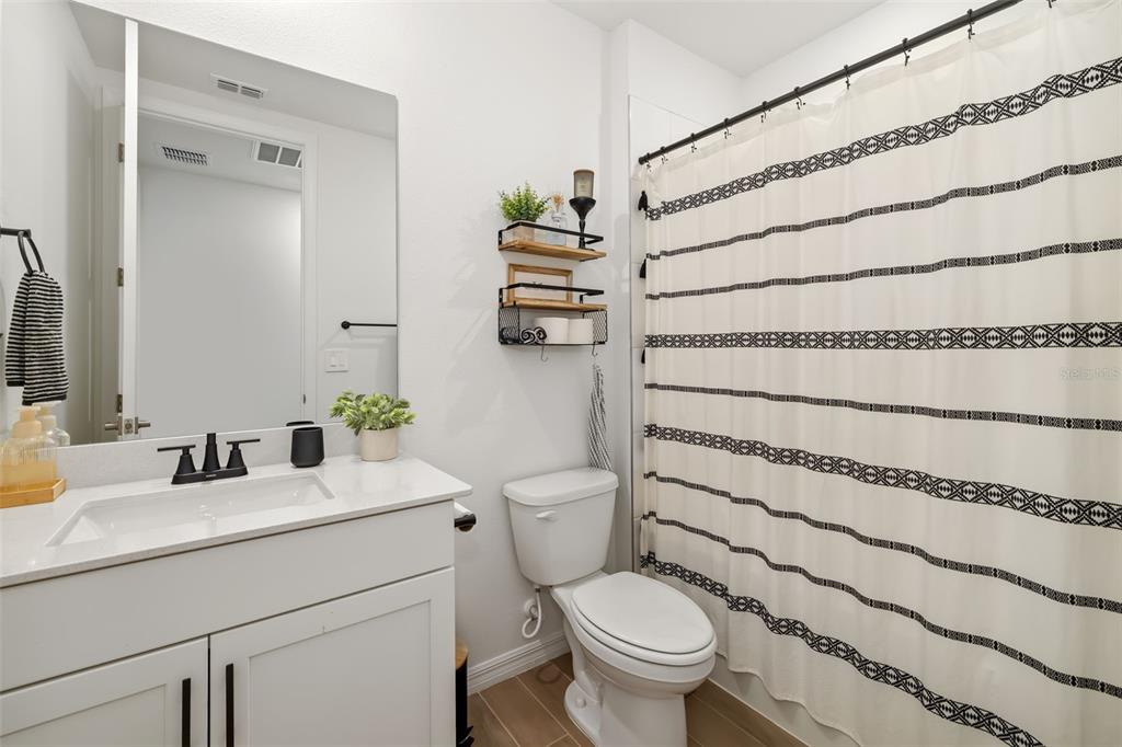 14086 Ginnie Spgs Way Parrish, FL 34219 - Photo 21 of 49 a bathroom with a sink toilet and shower