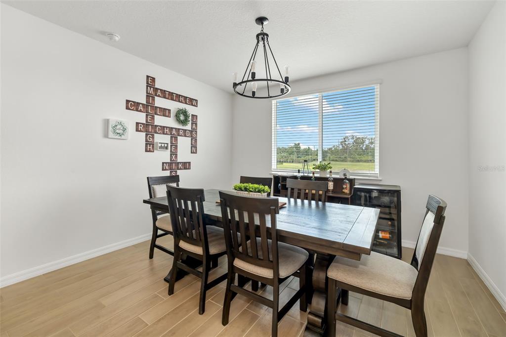 14086 Ginnie Spgs Way Parrish, FL 34219 - Photo 28 of 49 a view of a dining room with furniture window and wooden floor