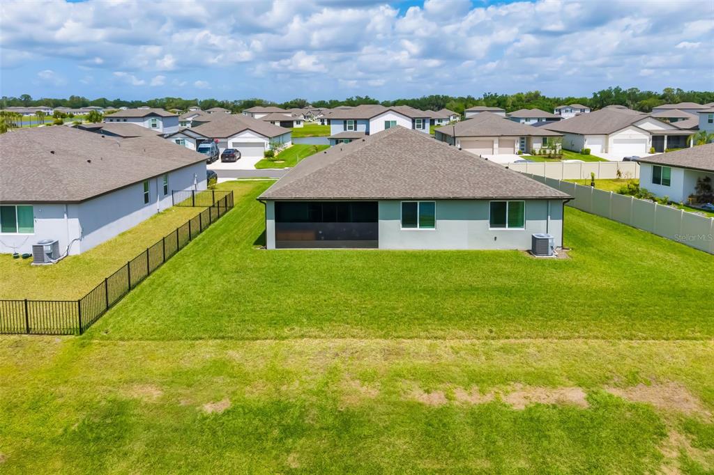 14086 Ginnie Spgs Way Parrish, FL 34219 - Photo 32 of 49 a aerial view of a house with swimming pool and a yard