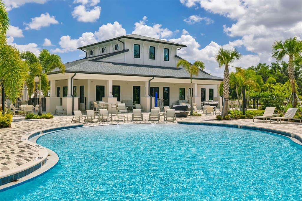 14086 Ginnie Spgs Way Parrish, FL 34219 - Photo 42 of 49 a front view of a house with swimming pool and chairs