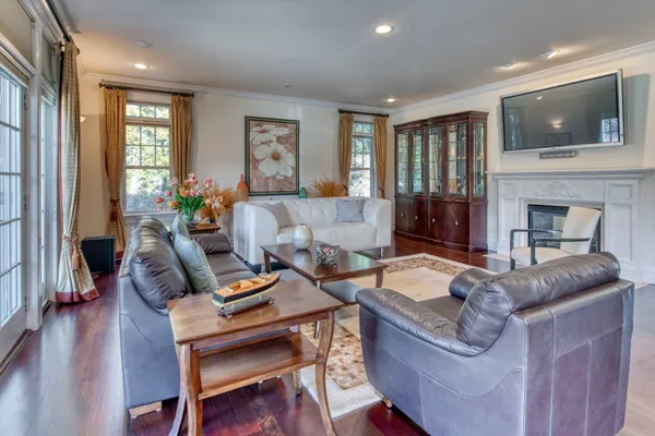 a living room with furniture a fireplace and a flat screen tv