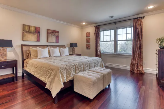 a spacious bedroom with a bed and a large window