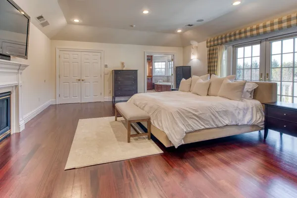 a bedroom with a bed window and a television