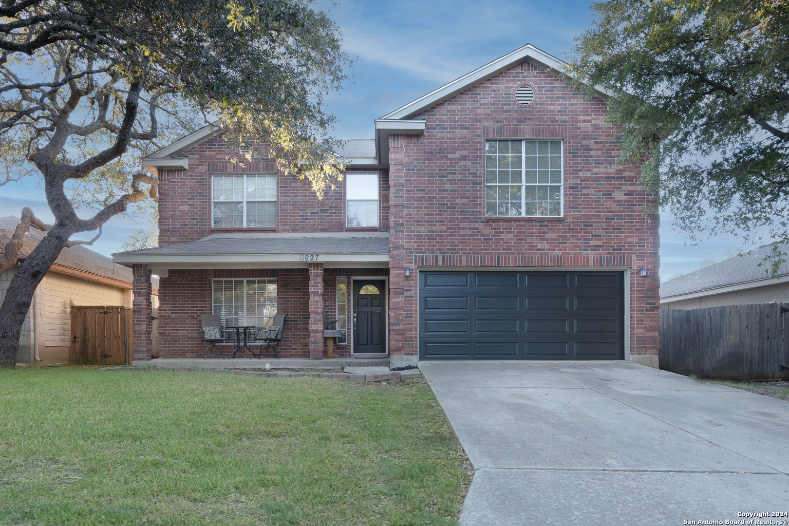 11827 Drought Pass Helotes, TX 78023 - Photo 1 of 1 a front view of a house with a yard and garage