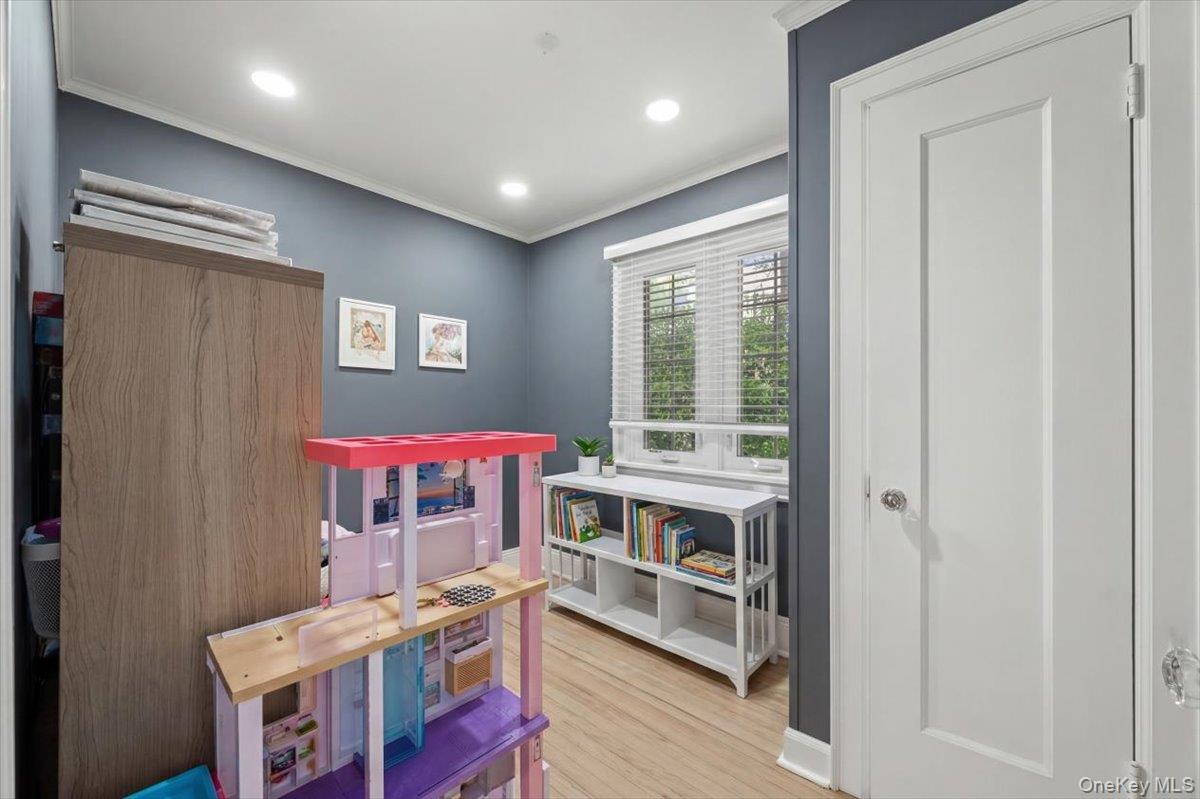 311 Lyncroft Road New Rochelle, NY 10804 - Photo 17 of 39 a room with furniture a flat screen tv and a window