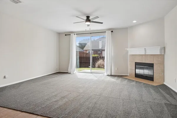 a view of an empty room with a fireplace